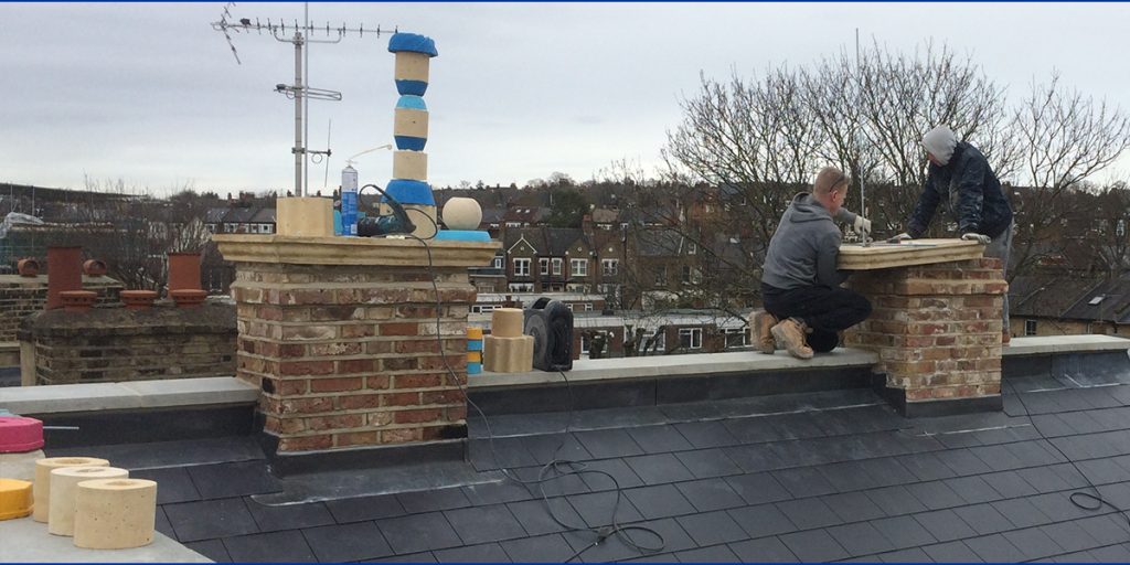 Builders attaching a threaded rod to the chimney crown to hold the sections of the chimney