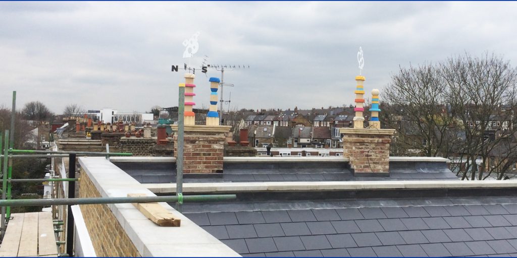 Finished chimneys on roof with weather vanes