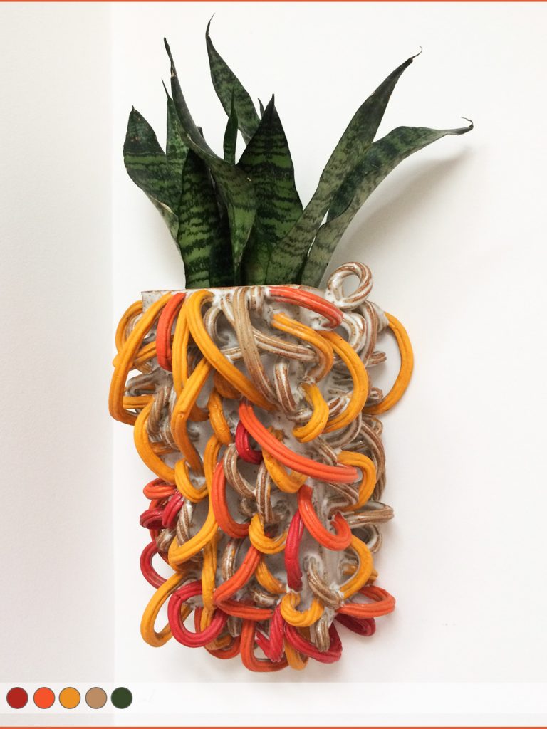 Clay planter decorated with red, orange, and yellow tendrils.