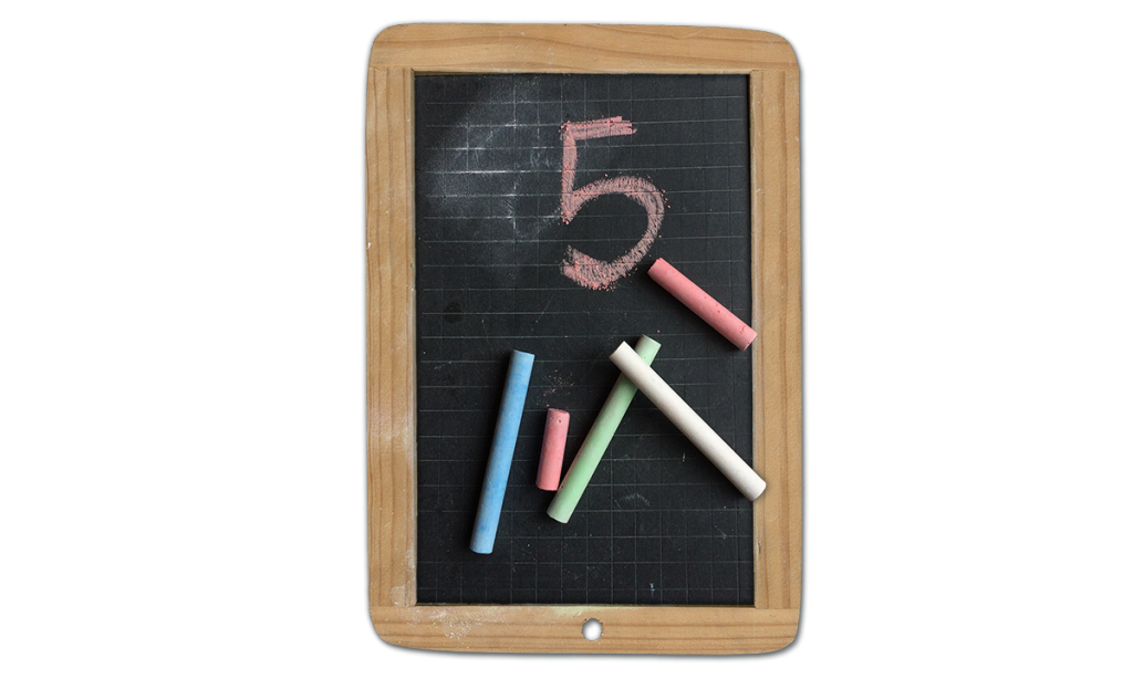 Five pieces of chalk with the number five written on a kids chalk board.