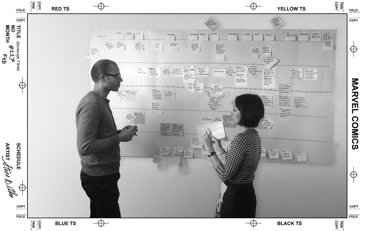 Two project mangers standing infant of a customer journey chart discussing story cards